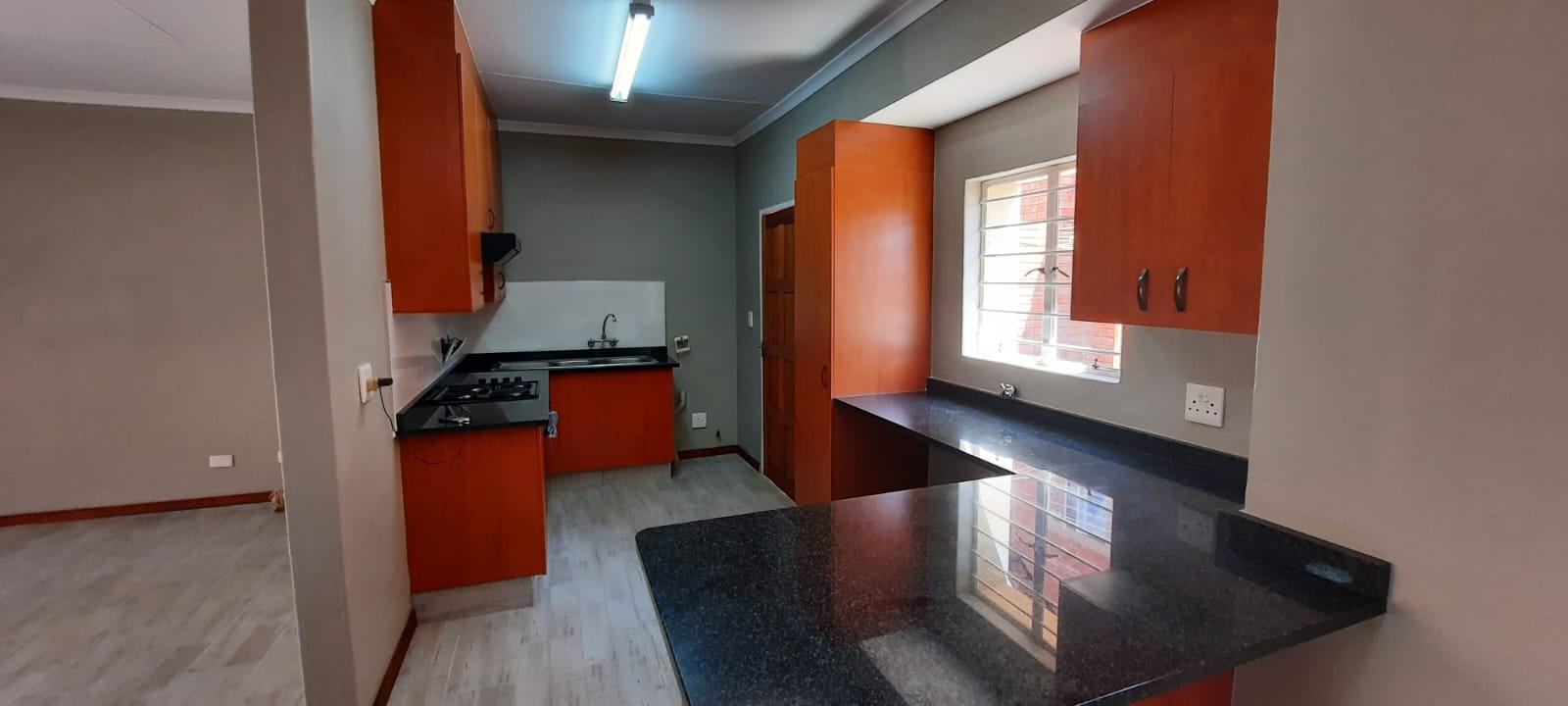 Finished kitchen: new floor, lighting and clean finishes
