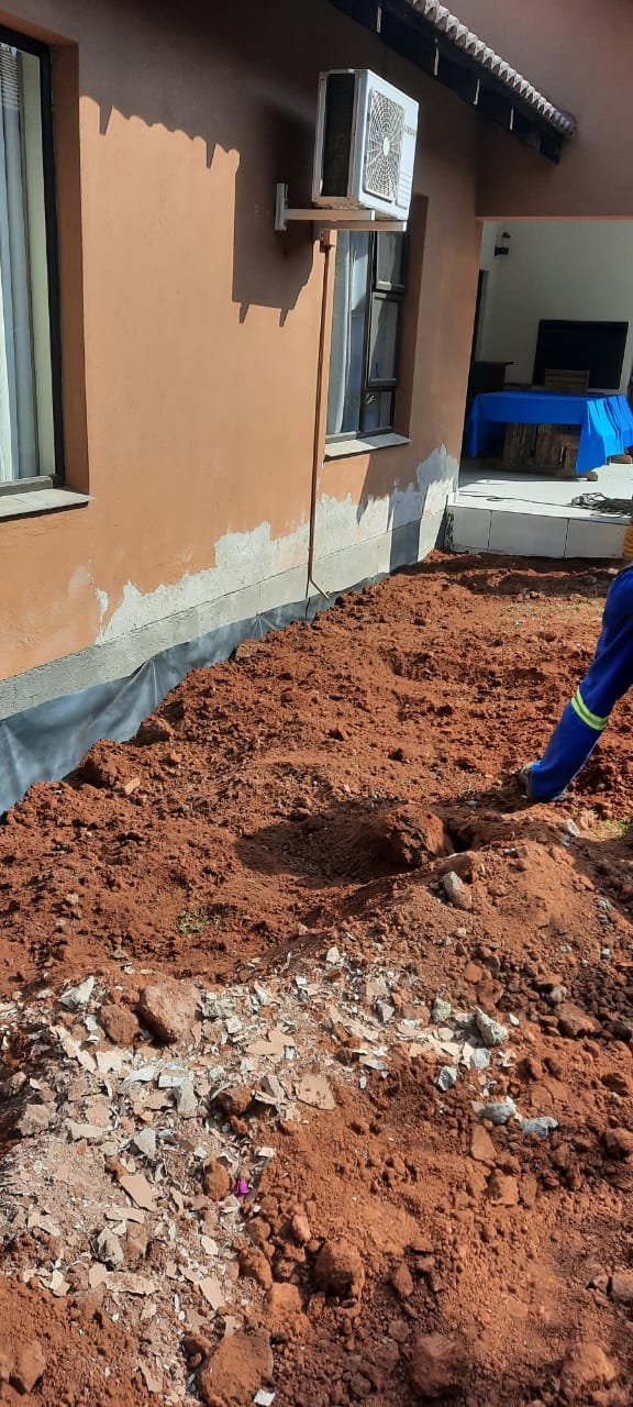 Foundation exposed showing damp damage